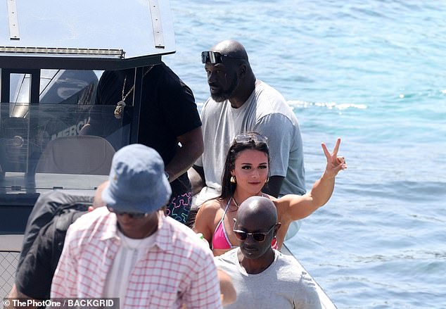 He seemed to be with a party of 11 people, including a brunette beauty in a hot pink bikini