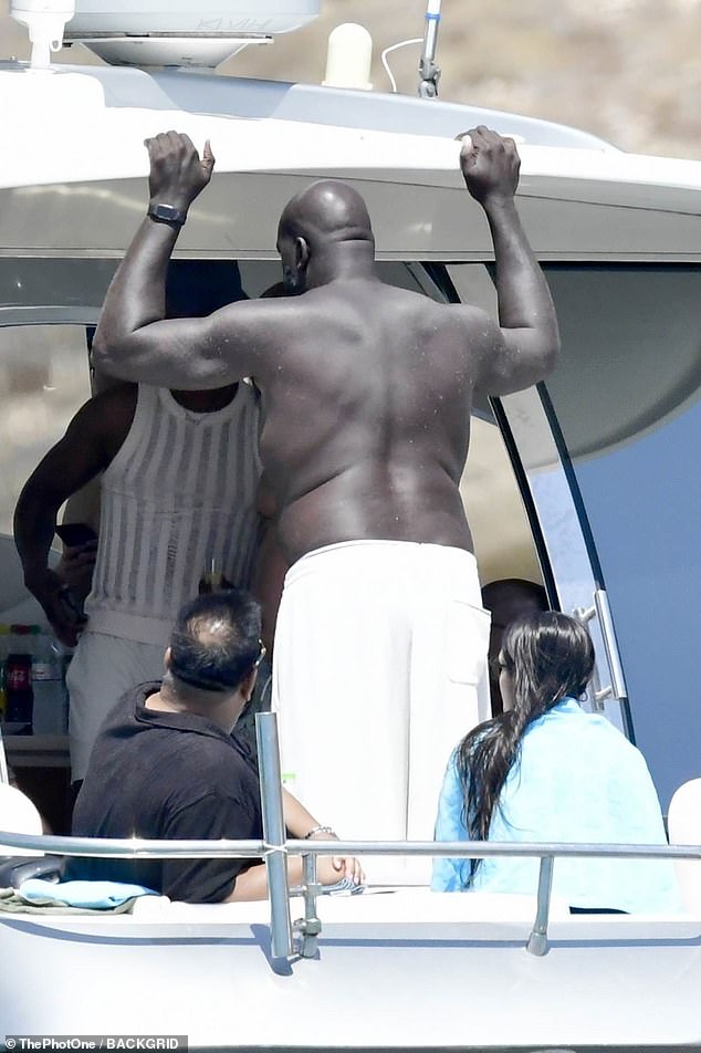 He was later spotted sunning his back with his shirt off at the back of the 70-foot boat