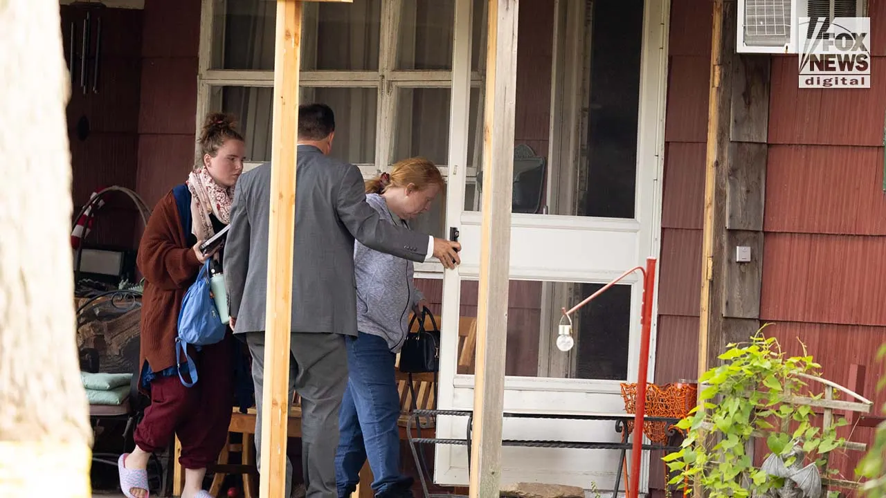 Asa Ellerup and Victoria Heuermann enter their home in Long Island