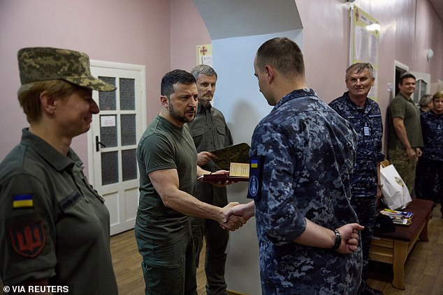 Ukraine's President Volodymyr Zelensky awards Ukrainian service members as he visits a military hospital in the town of Ochakiv