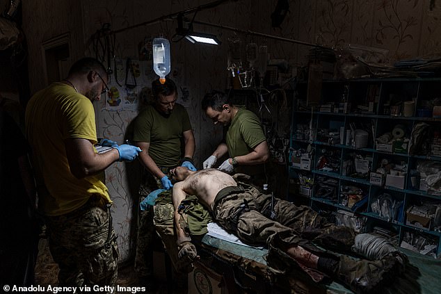 Ukrainian army medics treat wounded soldiers at a stabilisation point in the direction of Bakhmut