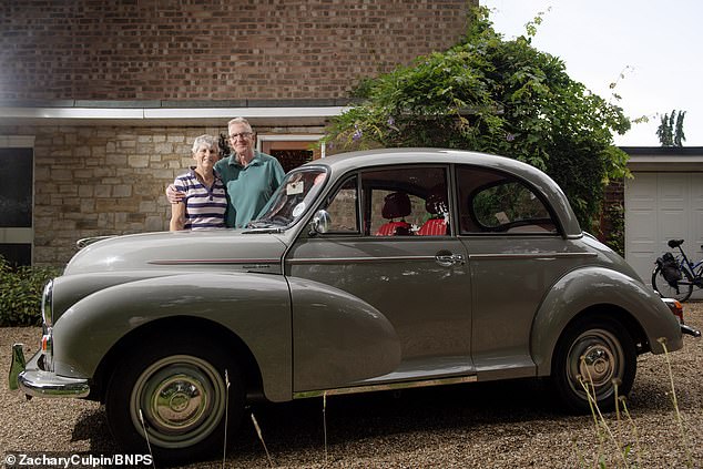 Greg (pictured with his wife) said: 'In the early years it was easy to source Minor spare parts from scrapyards, and there is a Morris Minor community today'
