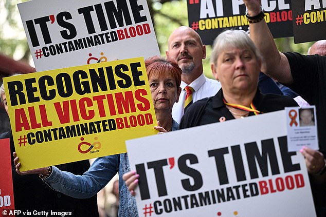 At least 2,900 NHS patients - including young children - died from being infected with HIV and hepatitis C through contaminated blood products in the 1970s and 1980s. Pictured, demonstrators outside the Infected Blood inquiry in London today, holding placards urging the Government to recognise all victims of the NHS infected blood scandal