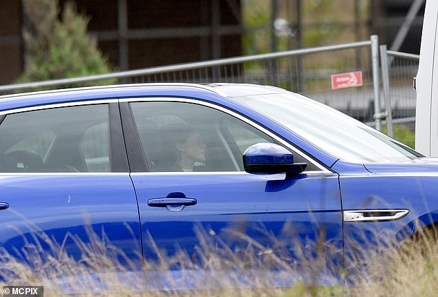 Action: Michelle was filmed driving off in a blue vehicle