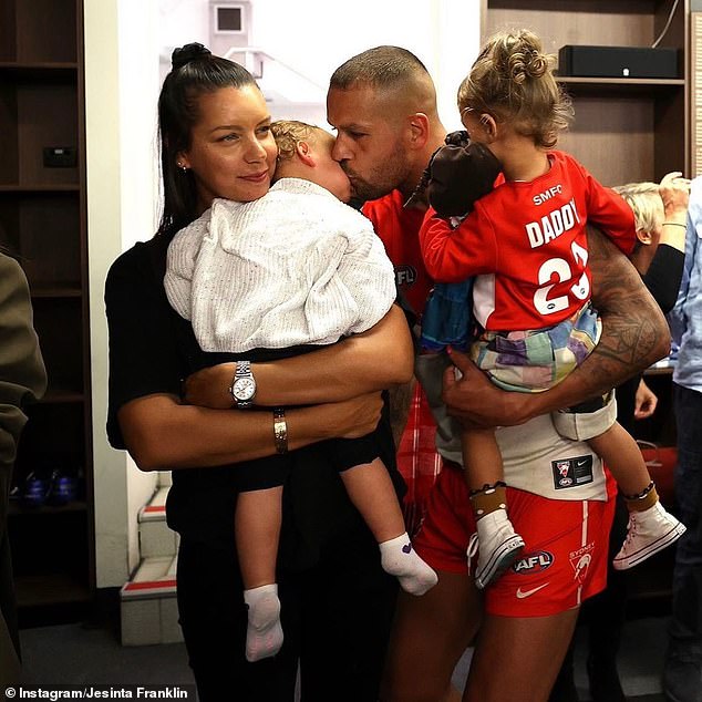 Franklin is seen holding his daughter Tullulah on his hip after a Swans game, accompanied by his sister Bianca (left)
