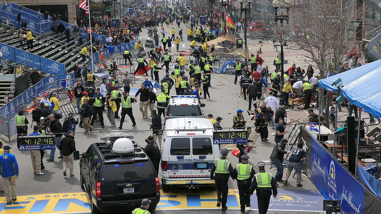 Scene of Boston Marathon finish line with tons of police and emergency vehicles 