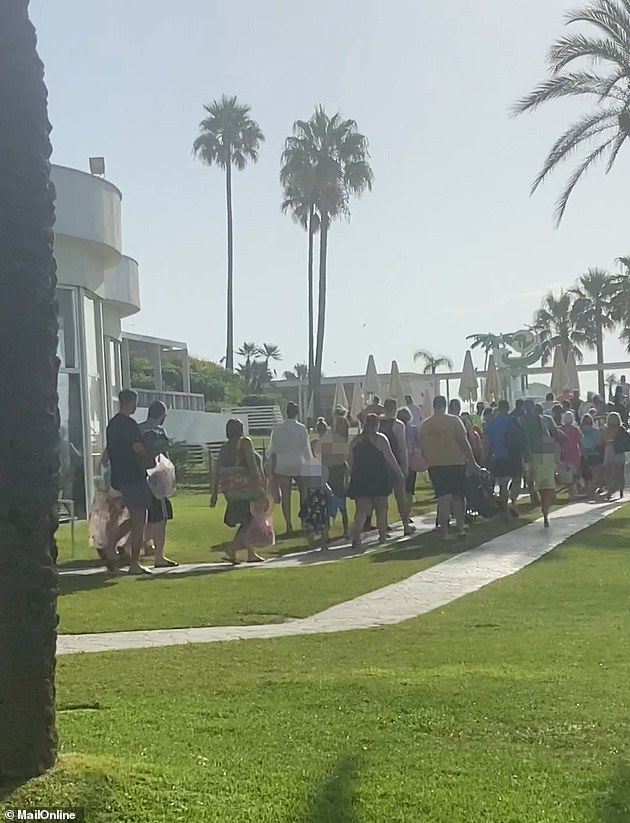 The footage in Benalmádena, Costa Del Sol, shows hundreds of vacationers waiting outside the pool area, only to start sprinting towards the sun beds as soon as the doors open