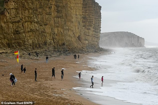 Miserable Rain and cooler temperatures are here to stay for the summer because a low pressure system is currently 'in charge of Britain's weather', experts say. Pictured is West Bay in Dorset at the weekend