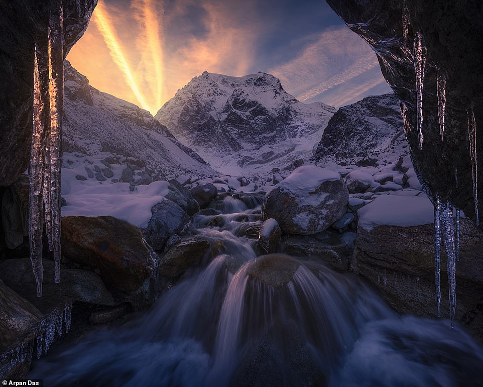 Icicles frame this evocative scene of freshly fallen snow in 'one of the most beautiful valleys' in the Swiss Alps. Das describes the setting as 'magic'