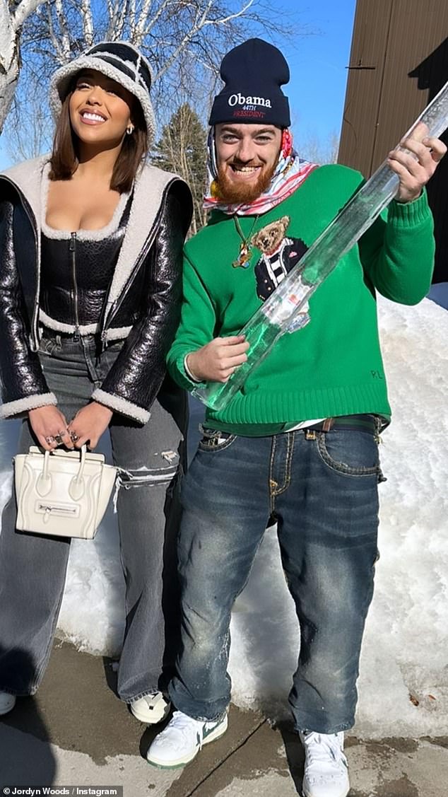 Happier times: Another photo made it clear that Angus was holding an enormous icicle that looked as if it might have come from a frozen rain gutter. He appeared to play some air guitar on it while grinning maniacally next to Jordyn