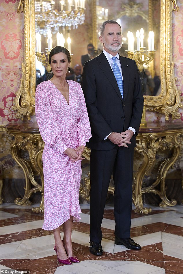King Felipe and Queen Letizia of Spain pictured in April this year at the Royal Palace in Madrid: Guy says the king's 'coat's lines flow into the trousers, making the outfit a coherent whole'