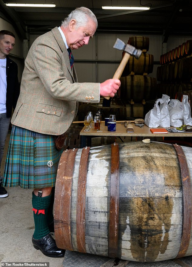 The King was invited to review the casks on-site with members of staff - which involved tapping the barrels