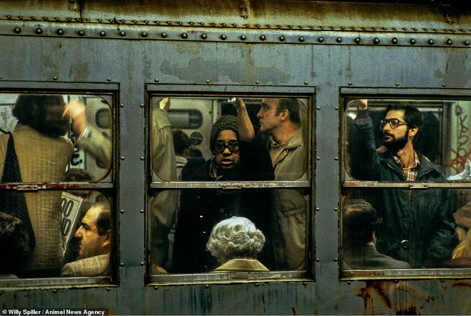 Rush Hour on Lexington IRT. A woman looks out of the window on a crowded subway train. Spiller said: 'Each car is a sweaty, rattling microcosm of the city itself – a loud, crowded, colorful melting pot where everyone is thrust into everyone else's business'