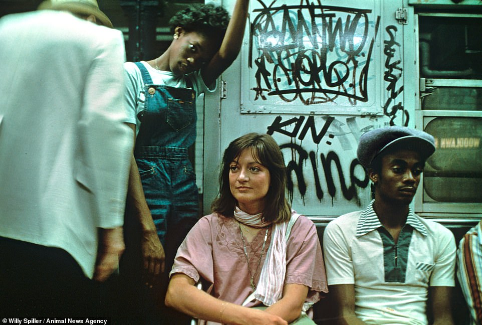 Jerome Avenue IRT Line, 1980. Passengers are seated in a graffitied carriage as a woman looks straight at the camera. Spiller said: 'The New York City subway system of the 1970s and 80s was sometimes referred to as Hell on Wheels. To me this conjures images of a steel prison, rattling through the underworld's eternal darkness'