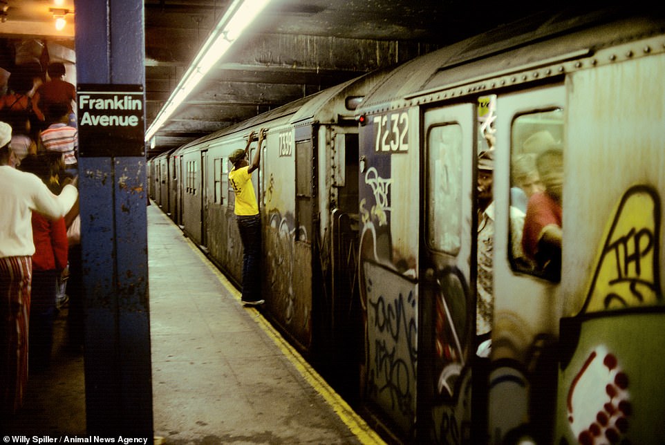 Dangerous Ride, Boy Clinging Outside a Subway Car, 1978. A boy holds on to the top of the carriage doors as the train prepares to depart from Franklin Avenue station. Spiller has always loved fairy tales, and in producing the shots relished the idea that the story may not always have a happy ending