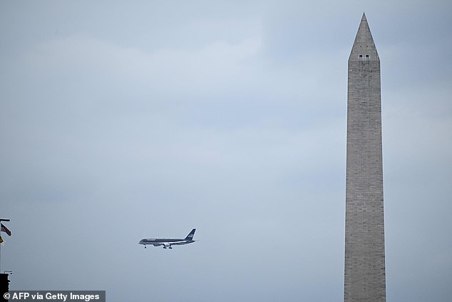 Trump said 'I'm being arrested for you' in a slew of messages as Trump Force One (pictured above) flew past the Washington Monument before touching down at Reagan National Airport