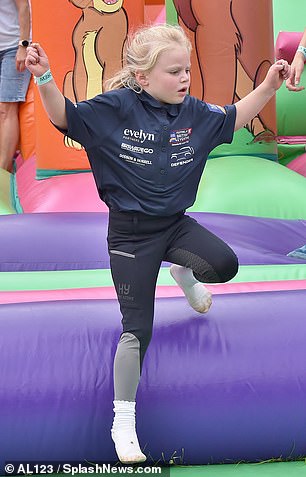 Lena, the youngest daughter of Mike and Zara Tindall, showing her skills on the bouncy castle