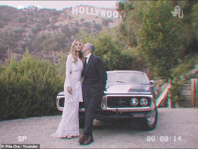 Mwah! The newlyweds posted next to a vintage car for official wedding photographs