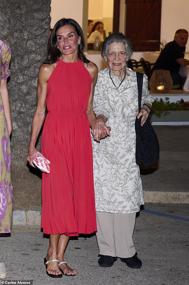 The Spanish Queen, 50, looked typically elegant in a red gown and gold sandals as they left the Mia restaurant in Palma de Mallorca
