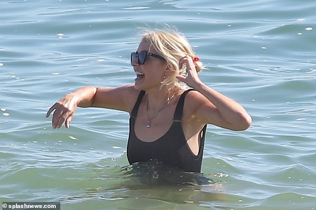 Cooling off:  She appeared in high spirits as she enjoyed a dip in the ocean