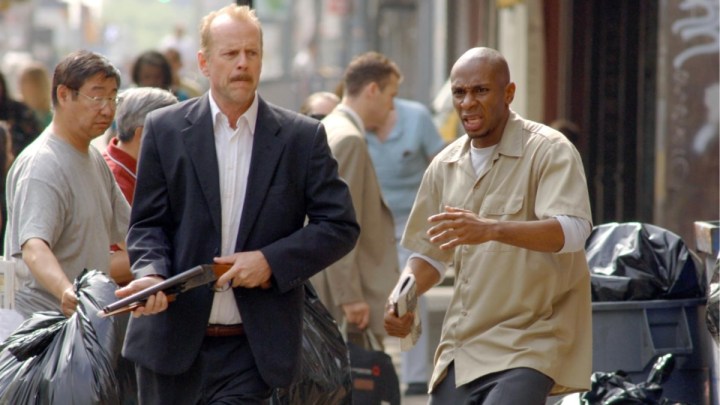 Bruce Willis holds a gun next to Mos Def in 16 Blocks.