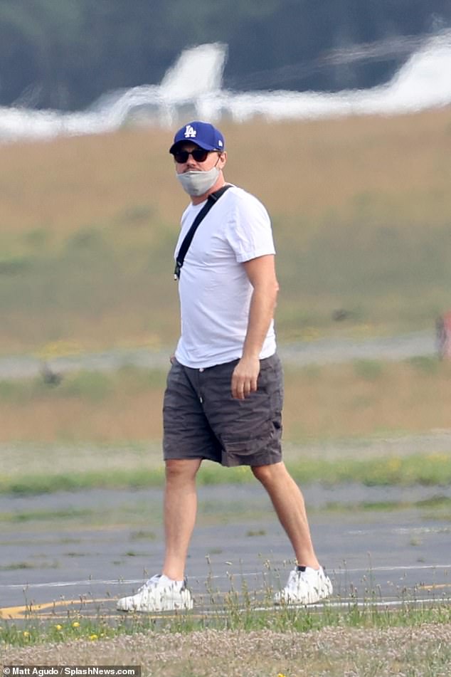 Leo arrives: DiCaprio was spotted arriving in the Hamptons via helicopter, with a mystery woman by his side