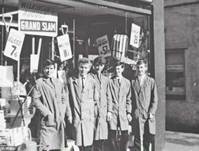 Pictured: Staff stood outside one of the Wilko stores, known then as Wilkinson, in the 1950s