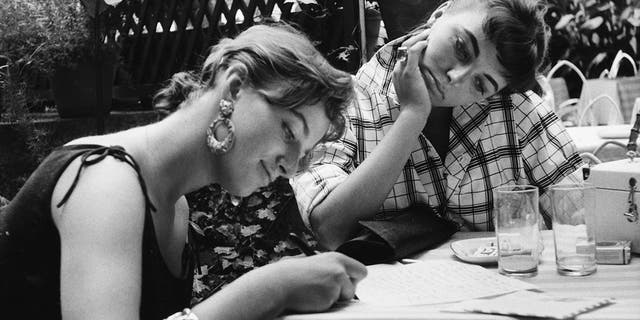 Joan Collins schaut ihrer Schwester Jackie Collins beim Schreiben zu