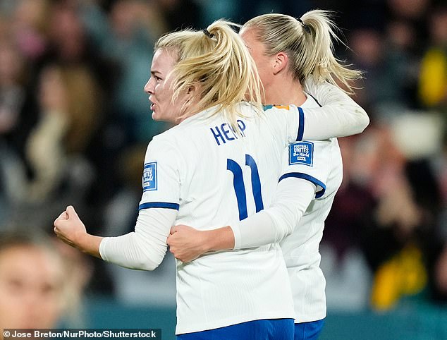 Hemp celebrates with teammate Russo after scoring England's equaliser