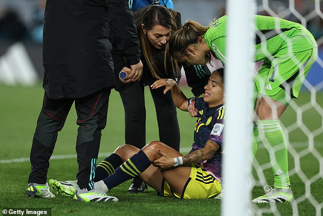 Carolina Arias of Colombia receives medical treatment early in the first half