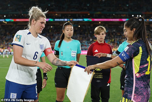 Millie Bright of England and Catalina Usme of Colombia swap match pennants