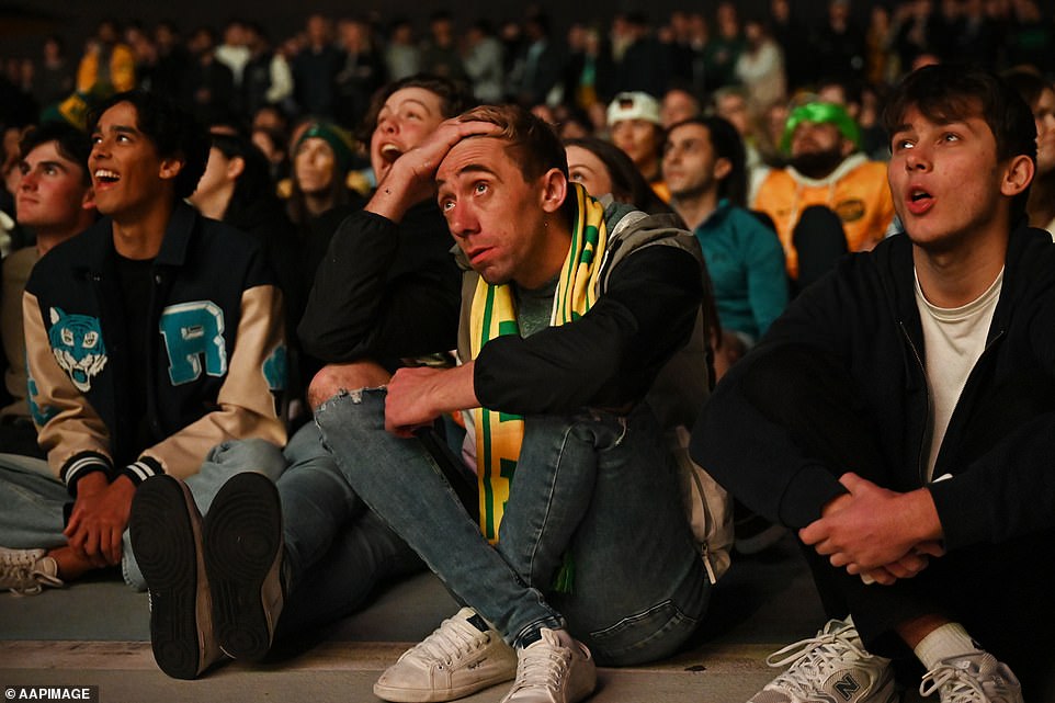 Australia fans react as they watch the live site screening of the semi-final match at Tumbalong Park in Sydney today