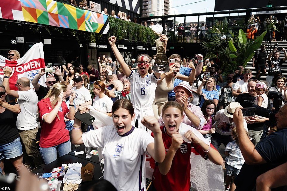 England fans celebrate at Boxpark Croydon in South London following a screening of the Women's World Cup semi-final today