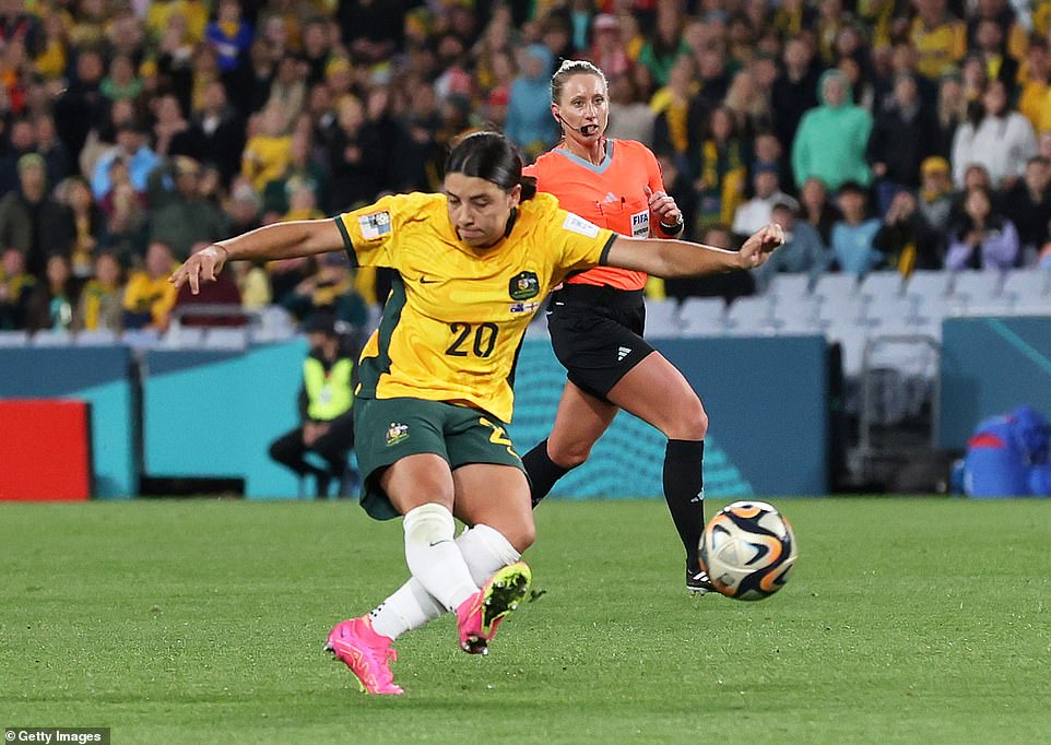 Sam Kerr (centre) of Australia celebrates with teammates after scoring her team's first goal in the semi-final today