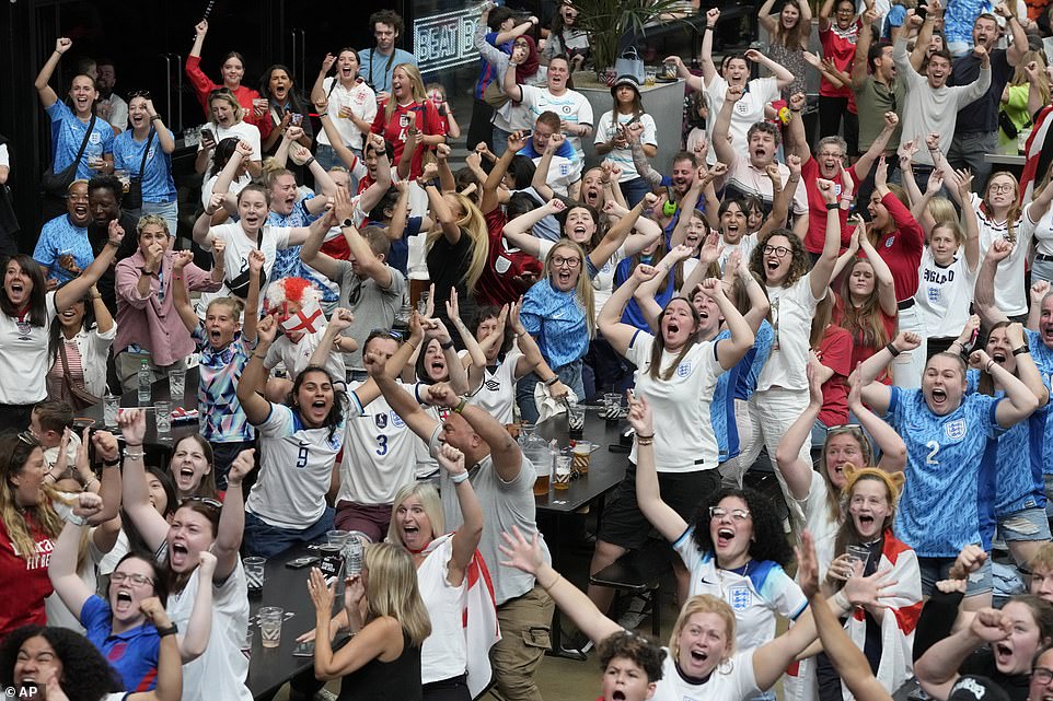 England fans cheer as England score their first goal at the screening of the match at Boxpark Wembley in London today