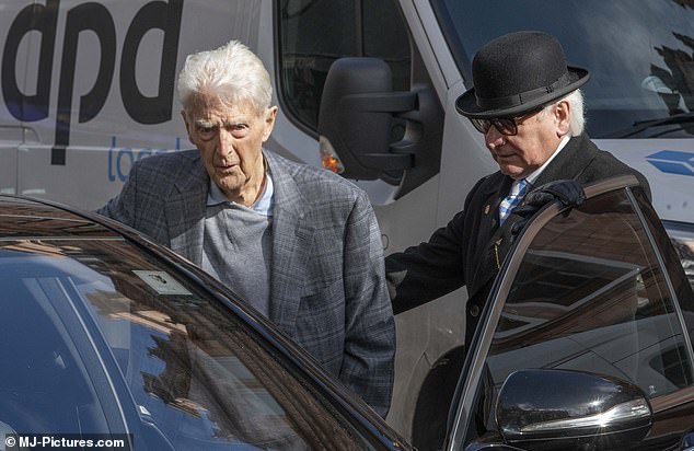 Sir Michael was assisted into the passenger seat of a car by a valet