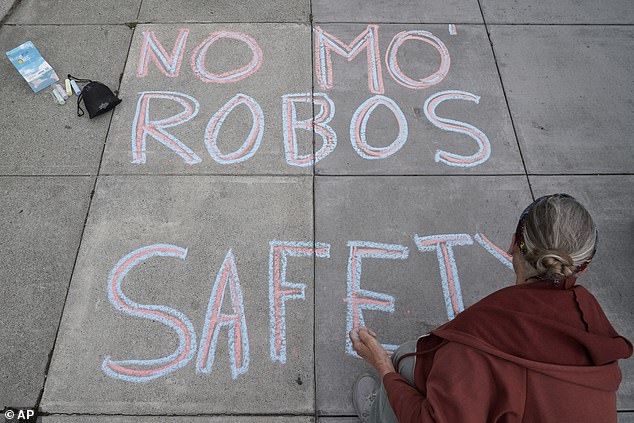 Martha Hubert writes a message opposing a proposed robotaxi expansion in San Francisco on Thursday, August 10