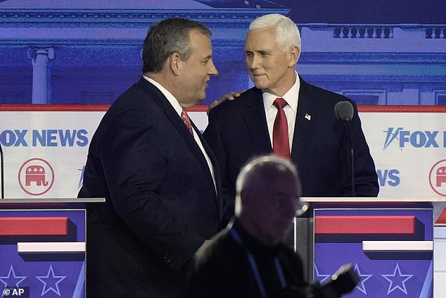 Chris Christie and Mike Pence chat during a commercial break