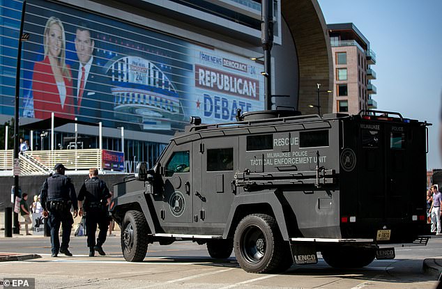 An armored vehicle and security personnel outside the Fiserv Forum before the start of the Republican presidential debate