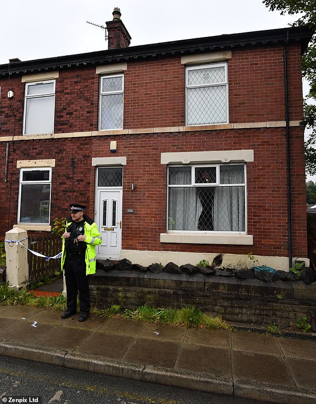 Officers were this morning standing guard outside the end-of-terrace home where Mr Patience's body was found