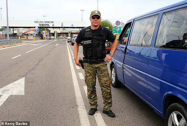 Respected diplomat Marek Magierowski told America¿s CNN the country is sending 10,000 troops to the Belarus border. Pictured: A Border Guard at Terespol border crossing in Poland
