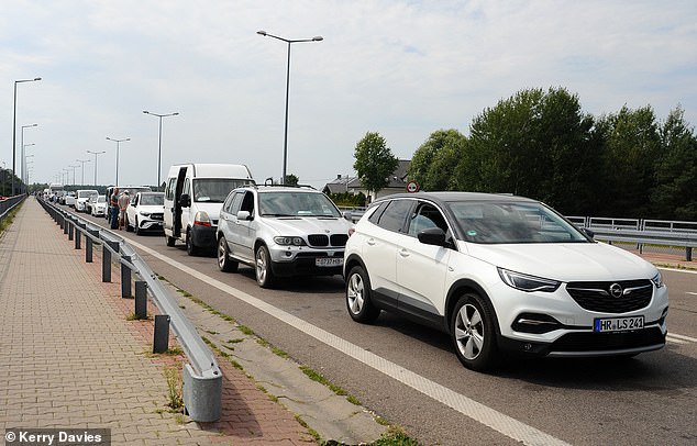 Teeming with border guards, the crossing is busy. Cars, buses and vans take as long as 24 hours to get into Poland as guards and the army conduct checks vehicle by vehicle on who is coming in ¿ and why