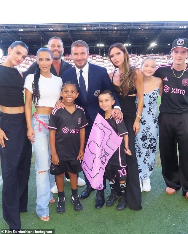 Support: Kim posed for photos with David and Victoria as she shared a series of photos from Lionel Messi's Inter Miami star-studded debut match last month
