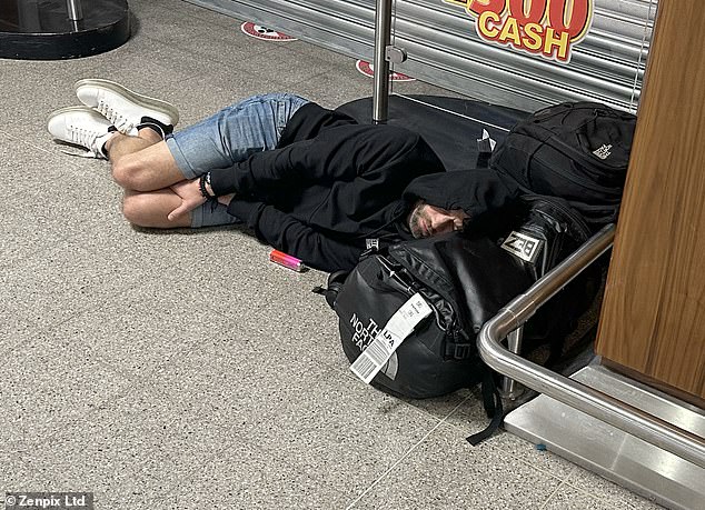A passenger sleeping on the floor at Manchester Airport early this morning