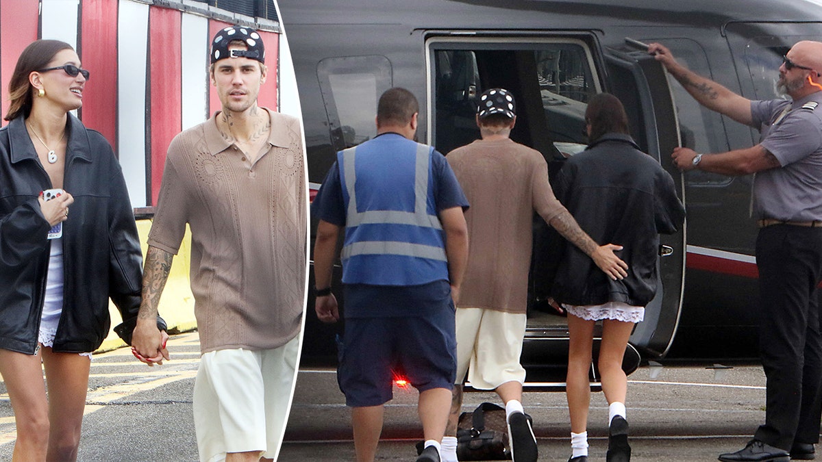 Hailey Bieber trägt eine Lederjacke und hält Händchen mit Justin Bieber in einem braunen Hemd mit Schlitz. Justin Bieber hält den unteren Teil von Haileys Rücken, als sie in einen Hubschrauber steigen