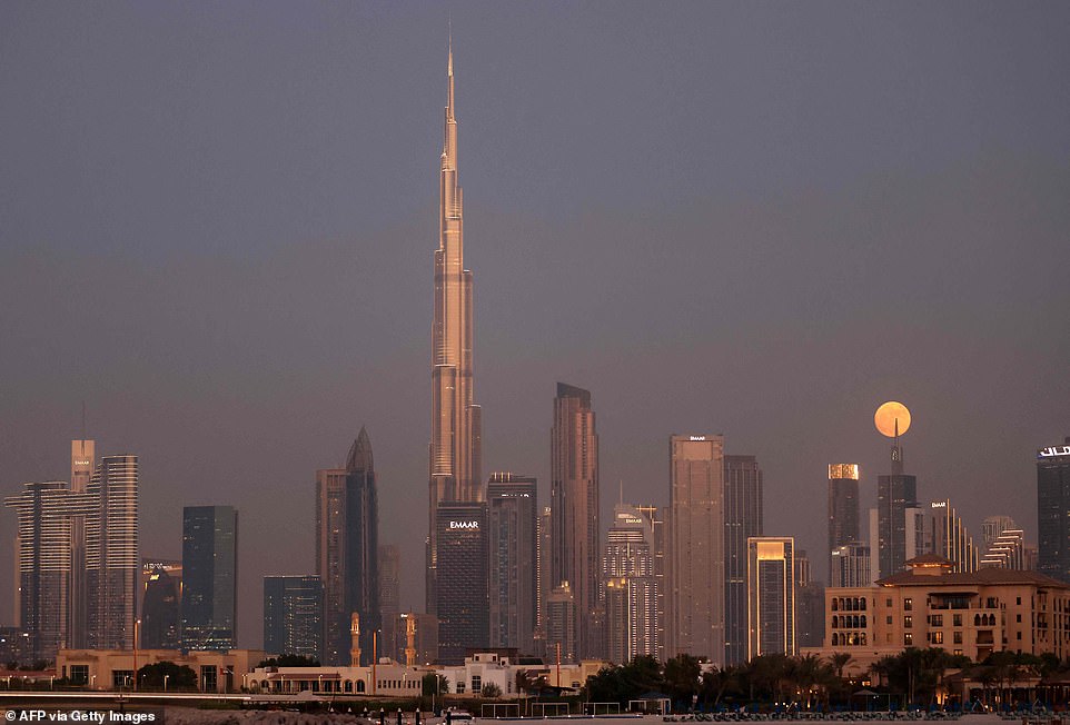 VEREINIGTE ARABISCHE EMIRATE: Der Blaue Mond geht hinter dem höchsten Gebäude der Welt, dem Burj Khalifa, und der Skyline von Dubai auf