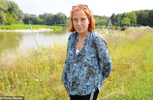 Poland is massively investing in its security and its military, effectively policing the eastern flank of the EU while the Ukraine conflict rages on its doorstep. Pictured: Sue Reid next to the River Bug, which is between Belarus and Poland