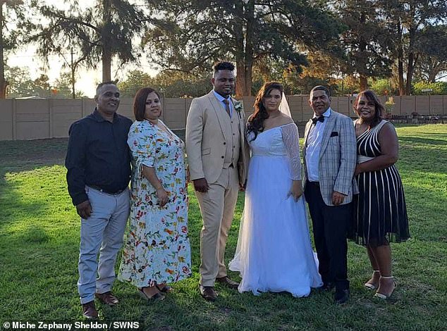Miche Zephany Sheldon, 26, from Cape Town, was walked down the aisle at her wedding by 'two dads' - her biological dad and the husband of the woman who kidnapped her at birth (Pictured groom Justin and bride Miche with their biological parents)