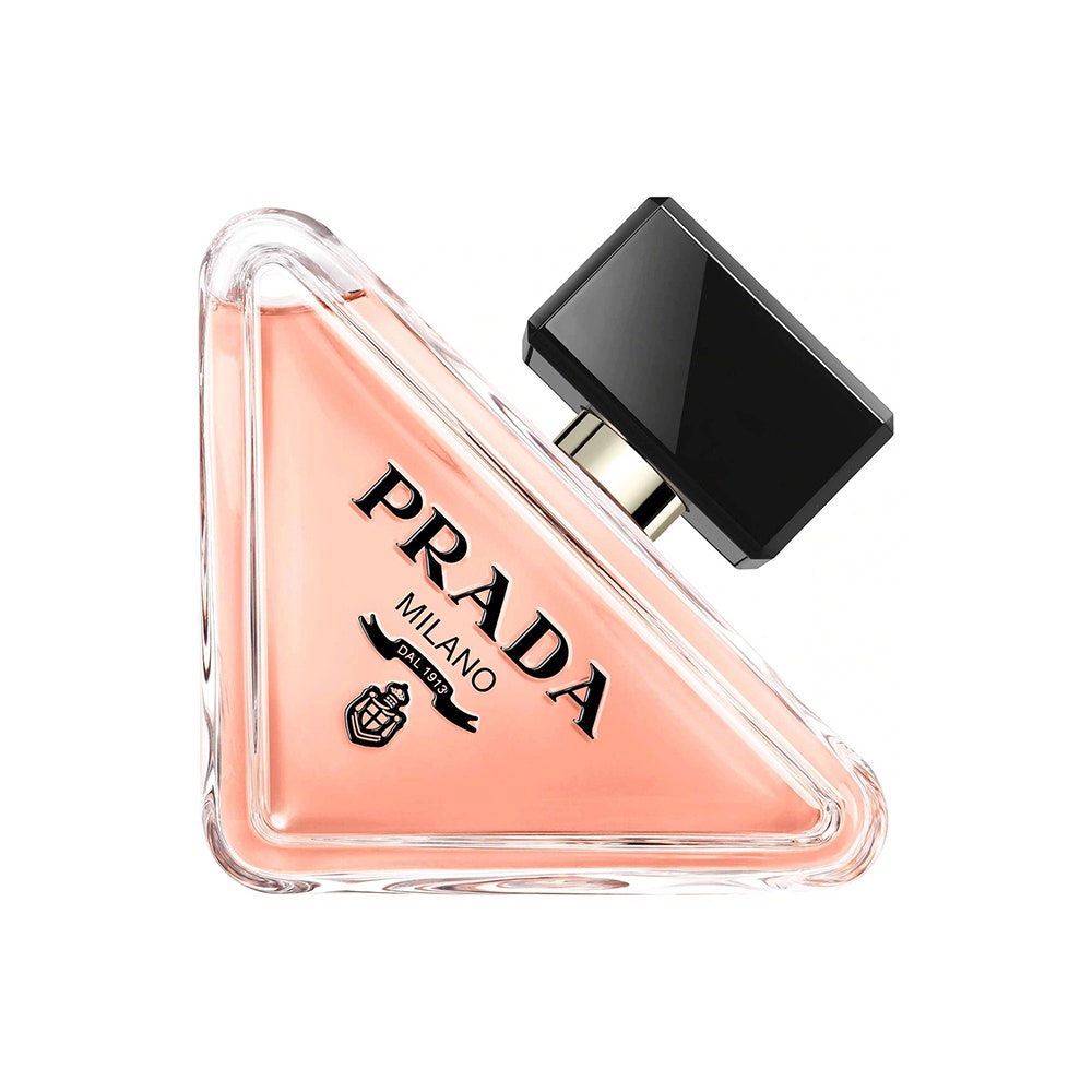 Prada Paradoxe Eau de Parfum triangle bottle of peach perfume with black cap on white background