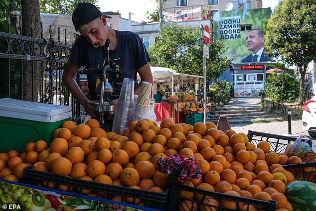 Squeezed: Turkish consumer prices rose 47.8% last month, a substantial increase from 38.2% recorded in June. Pictured: A street seller in Istanbul